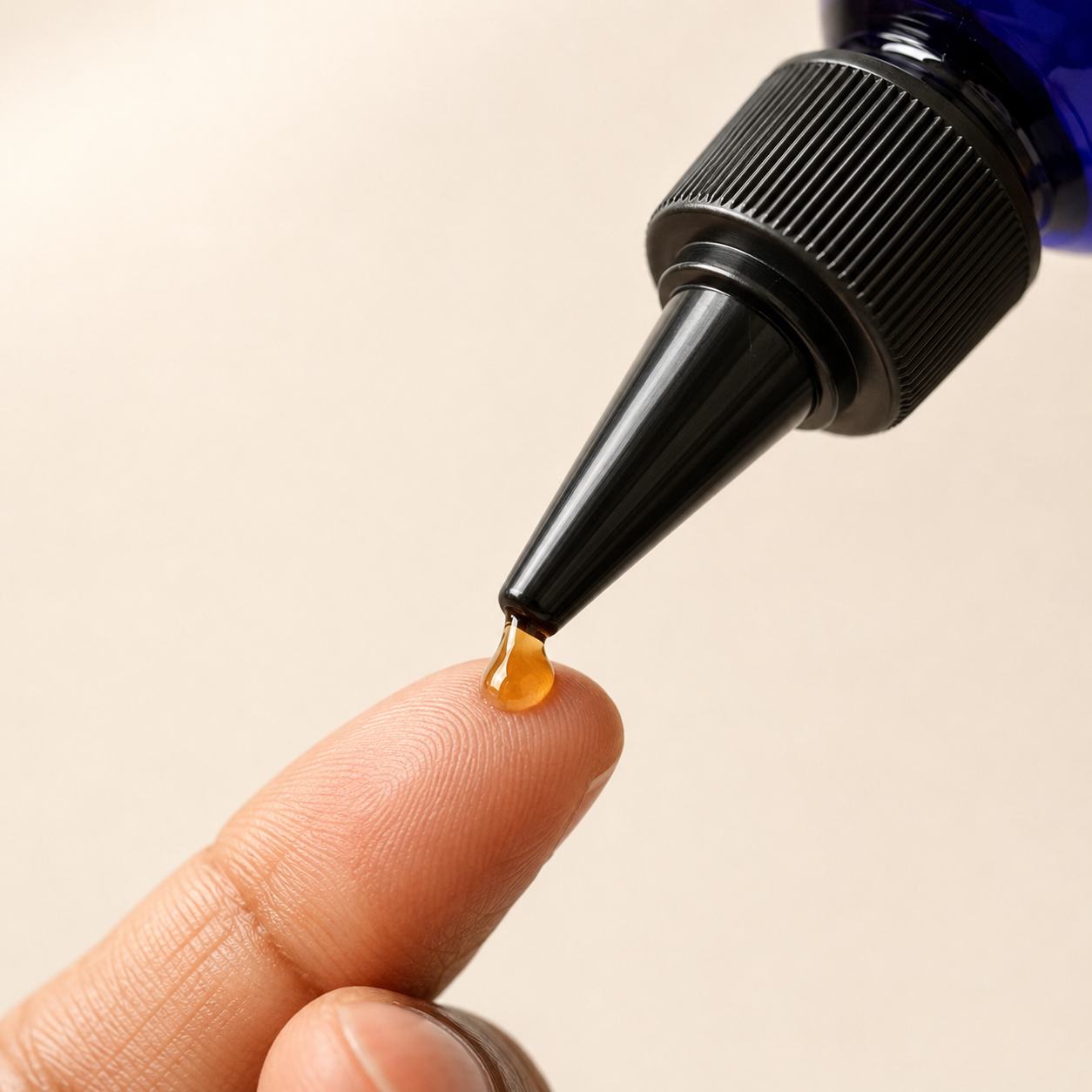 Close-up of Gigi's Promise Ayurvedic Growth Oil applicator tip and oil texture.