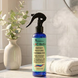 Loc Bliss Post Wash Conditioning Spray in a sunny and clean bathroom with steam and moisture